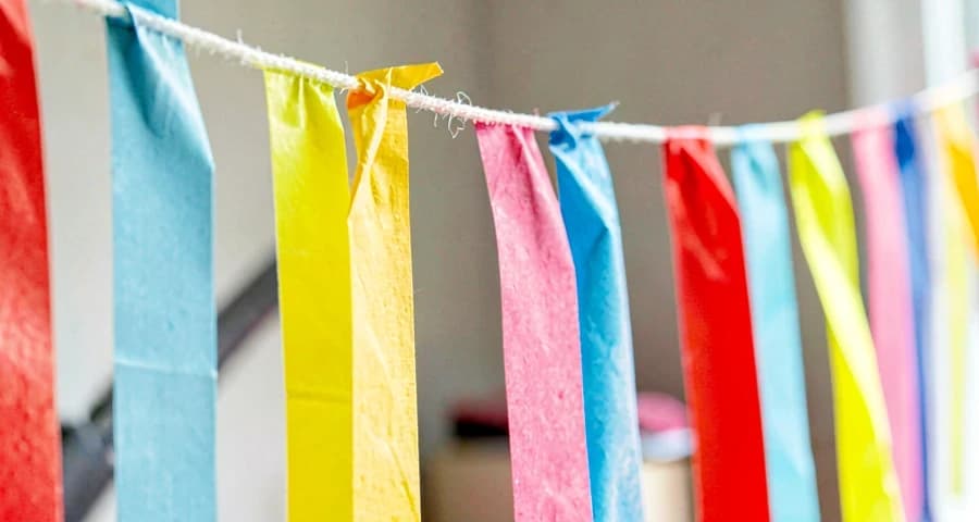 cortina de tiras de papel coloridas usada em atividade sensorial na creche
